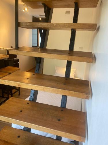 a room with wooden shelves on the wall at French Andes Apart Hostel in Pucón
