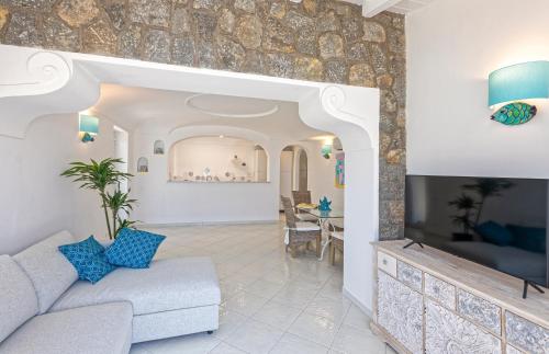 a living room with a couch and a table at Villa dei Lecci - 7 Luxury villas with private pool or jacuzzi in Ischia