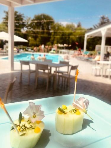 two pieces of food on a table next to a pool at Hotel Santacroce Meeting in Sulmona