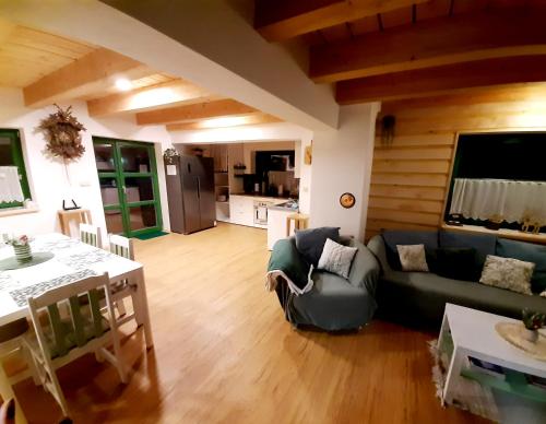 a living room with a couch and a table at Zelený Jelen - horský apartmán in Stachy
