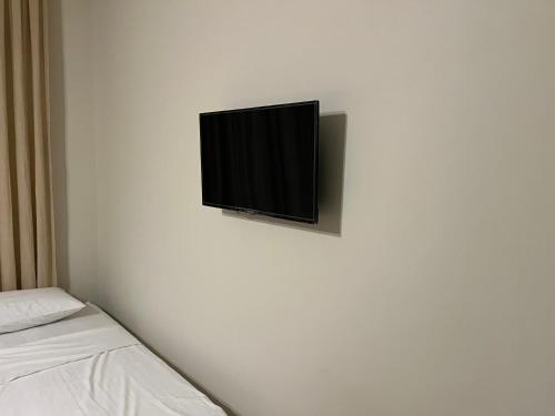 a flat screen tv hanging on a white wall at Hotel Tatul in Momchilgrad