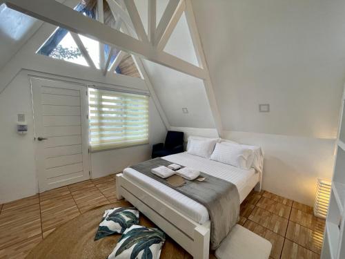 a bedroom with a large bed and a window at La View Mountain Resort in Damasanan