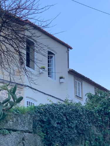a white house with two windows and a fence at Element in Viseu