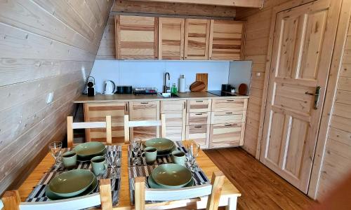 a kitchen with a table and chairs in a room at Browarówka in Łomnica