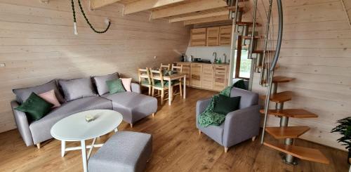 a living room with a couch and chairs and a table at Browarówka in Łomnica