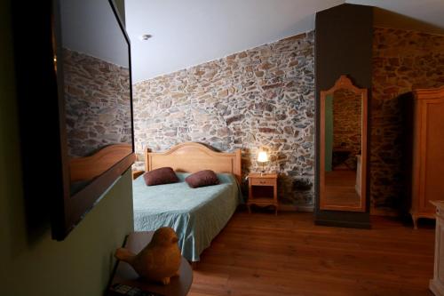 a bedroom with a bed and a mirror at Mas Renart in Mollet de Perelada