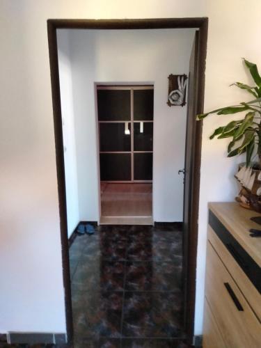 a mirror view of a hallway with a door at pensiune Valentin, apartament 2 dormitoare cu terasa, Iulius Mall in Timişoara