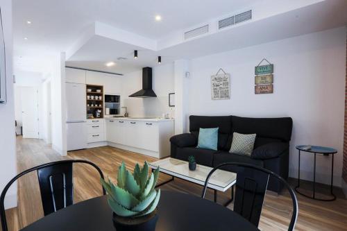 a living room with a couch and a table at VELALMA PISOS centro histórico in Jaén