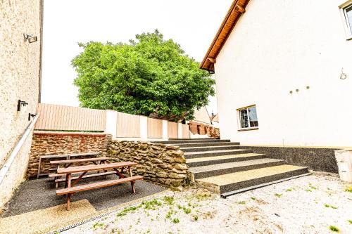 a picnic table and stairs in front of a building at JEZ&SPI Plánice in Plánice