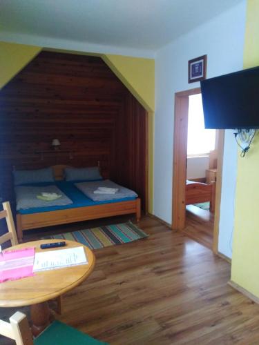 a small room with a bed and a table at Penzion Olga in Mariánské Lázně