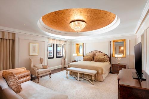 a bedroom with a bed and a living room at The Oberoi Madina المدينة أوبروي in Al Madinah