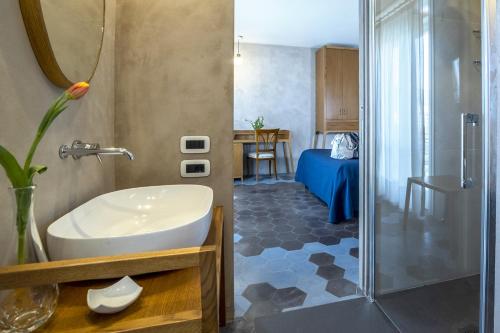 a bathroom with a tub and a sink and a shower at Il Roseto in Sorrento