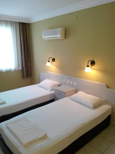 a hotel room with two beds and a air conditioner at Sailor Apart Hotel in Alanya