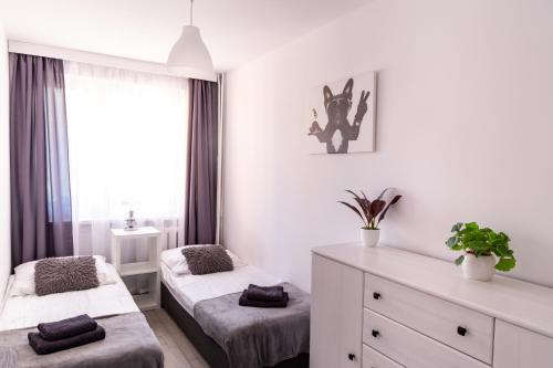 Posteľ alebo postele v izbe v ubytovaní Apartament Anna