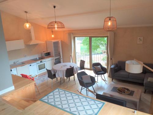 a kitchen and living room with a table and chairs at Gites de l'alouette in Boffres