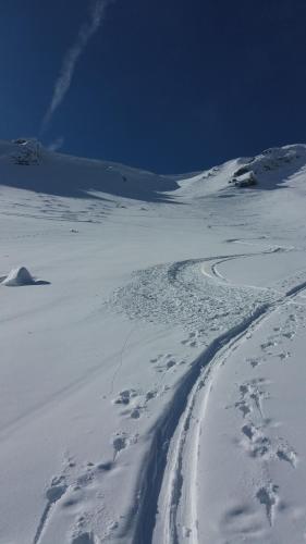 a snow covered mountain with a trail in the snow at Ferienwohnung mit wundervollen Bergblick in Lenggries