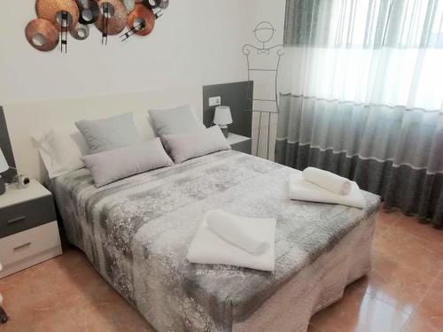 a bedroom with a bed with two white towels on it at CASA LILLA in Riumar
