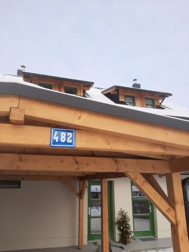 a building with a clock on the top of it at Zelený Jelen - horský apartmán in Stachy