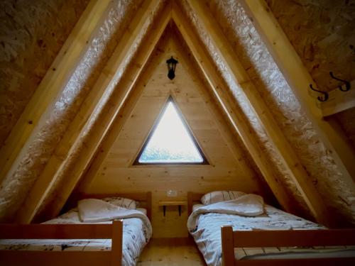 two beds in the attic of a tree house at BB CHALET in Kolašin
