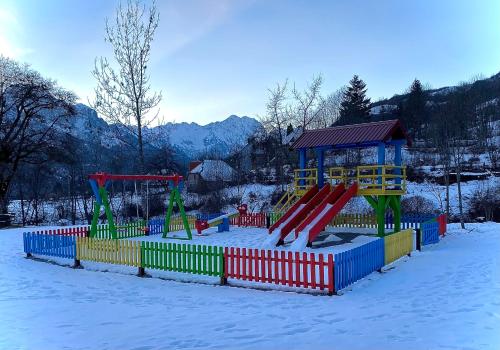 a playground with a slide in the snow at BB CHALET in Kolašin