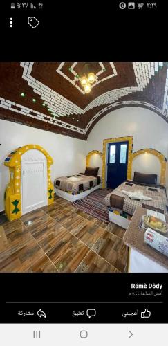 a picture of a room with two beds in it at Old Nubian guest house in Aswan
