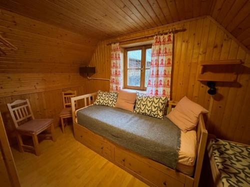 a bedroom with a bed in a log cabin at Chalupa Čičmany in Čičmany