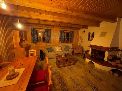 a living room with a couch and a fireplace at Chalupa Čičmany in Čičmany