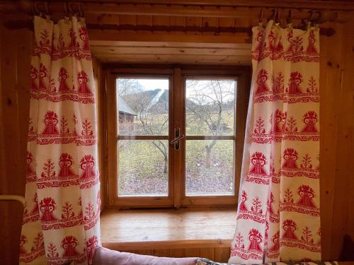 a window in a room with curtains in front of it at Chalupa Čičmany in Čičmany