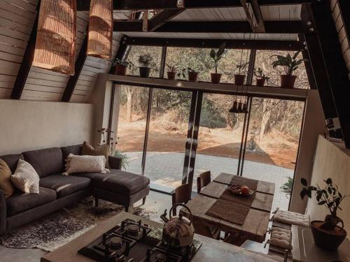 a living room with a couch and a table at Shepherds Rest in Hoedspruit