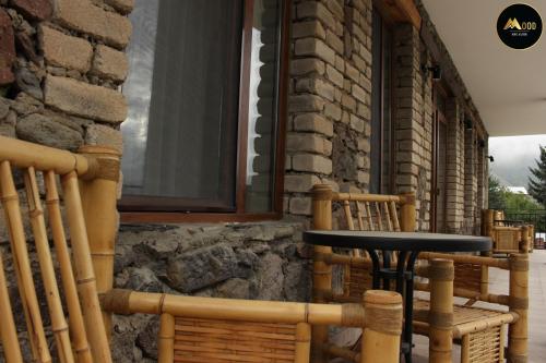 a black table sitting in front of a building at Mood Hotel Kazbegi in Stepantsminda