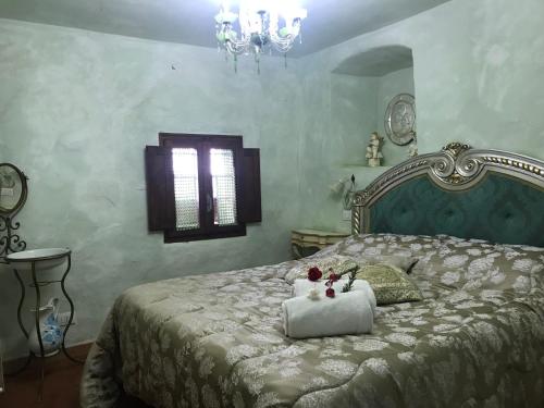 a bedroom with a large bed with a white bedspread at Il Fiorino di Badia in Badia A Passignano