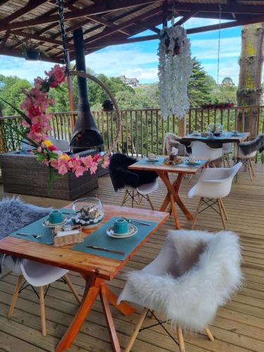 a patio with tables and chairs and a fountain at Recanto dos Moinhos - Boutique Hotel in Campos do Jordão