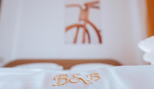 a bed with the word bed written on it at Pensiunea Bike&Bed in Moieciu de Jos