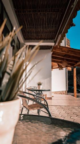 a group of tables and chairs on a patio at Pensiunea Bike&Bed in Moieciu de Jos