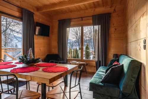 a dining room with a table and a couch at Litworowy Dom in Kościelisko