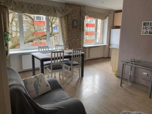 a living room with a couch and a table and a kitchen at Find for the traveler in Tallinn