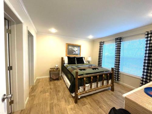 a bedroom with a bed and a large window at Mountain views, pets welcome-lake and river access in Lake Lure