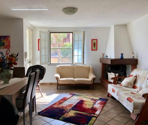 a living room with a couch and a table at Villetta Dei Glicini in Santa Caterina