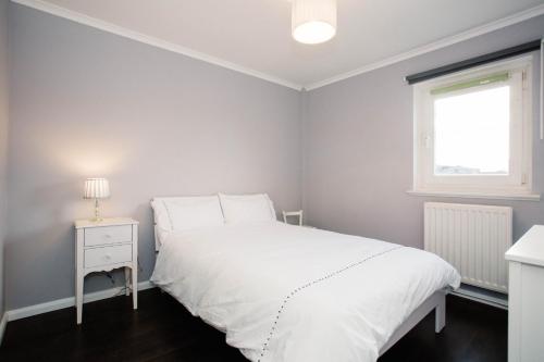 a bedroom with a white bed and a window at 2 DoubleBed Rooms Flat Aberdeen City, near University in Aberdeen