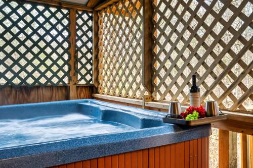 a jacuzzi tub in a gazebo with a bottle at Gnome Alone in Sevierville