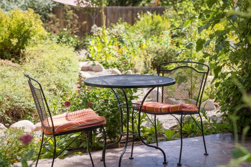 two chairs and a table and a table and chairs at Sunflower Hill Inn in Moab