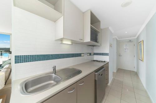 a kitchen with a sink and a counter at Bella Mare - 2 Bedroom Ocean View Terrace Apt in Ettalong Beach