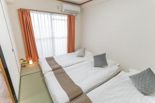Säng eller sängar i ett rum på stay's ジローズ浄心 602号 名古屋 民泊 駅近