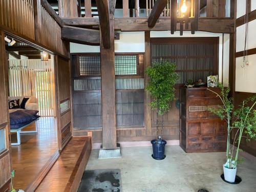 a living room with wooden walls and a ceiling at hanare in Yamanashi