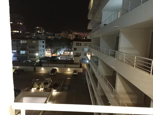 a view from the balcony of a building at night at Departamento full a pasos de la playa in Viña del Mar