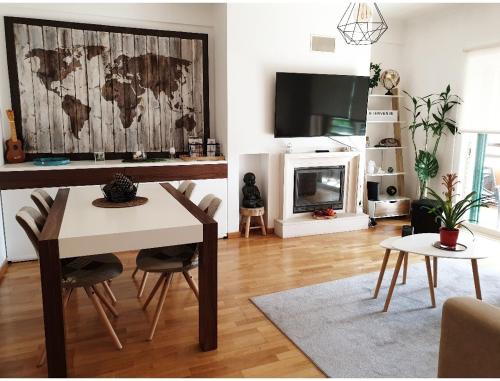 a living room with a table and a fireplace at Aroeira Lisbon Golf & Beach in Charneca