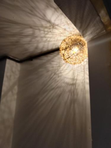 a light on a ceiling with a curtain at Lavendrata I in Phnom Penh