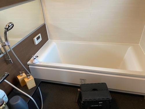 a bath tub in a bathroom with a shower at hanare in Yamanashi