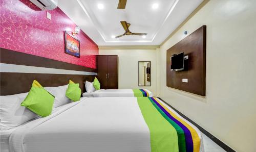 a bedroom with a large bed with at Treebo Sripadha Residency Alipiri Road in Tirupati