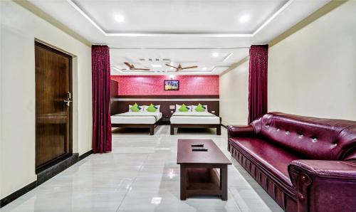 a living room with a couch and a table at Treebo Sripadha Residency Alipiri Road in Tirupati